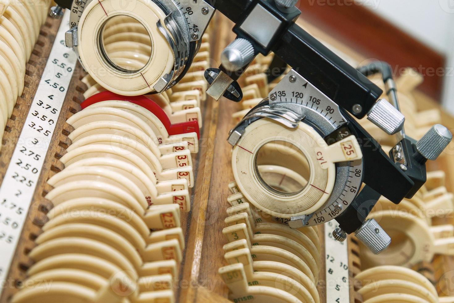 Optician with set of trial frames and trial lenses photo