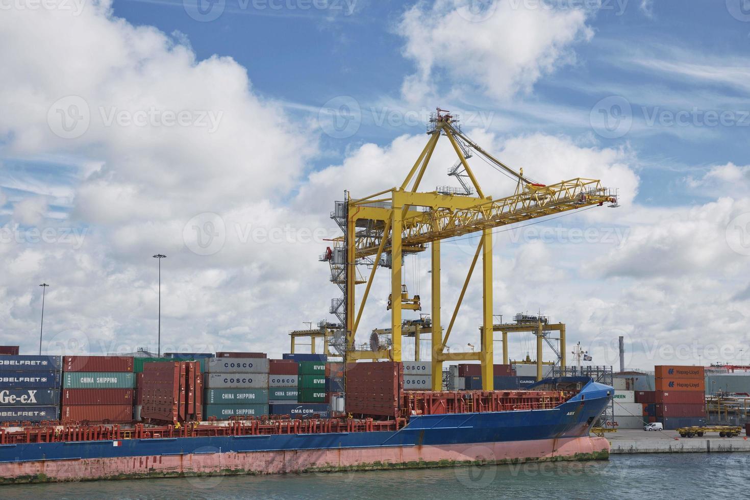 Large industrial cranes loading container ship in Dublin Port in Ireland photo