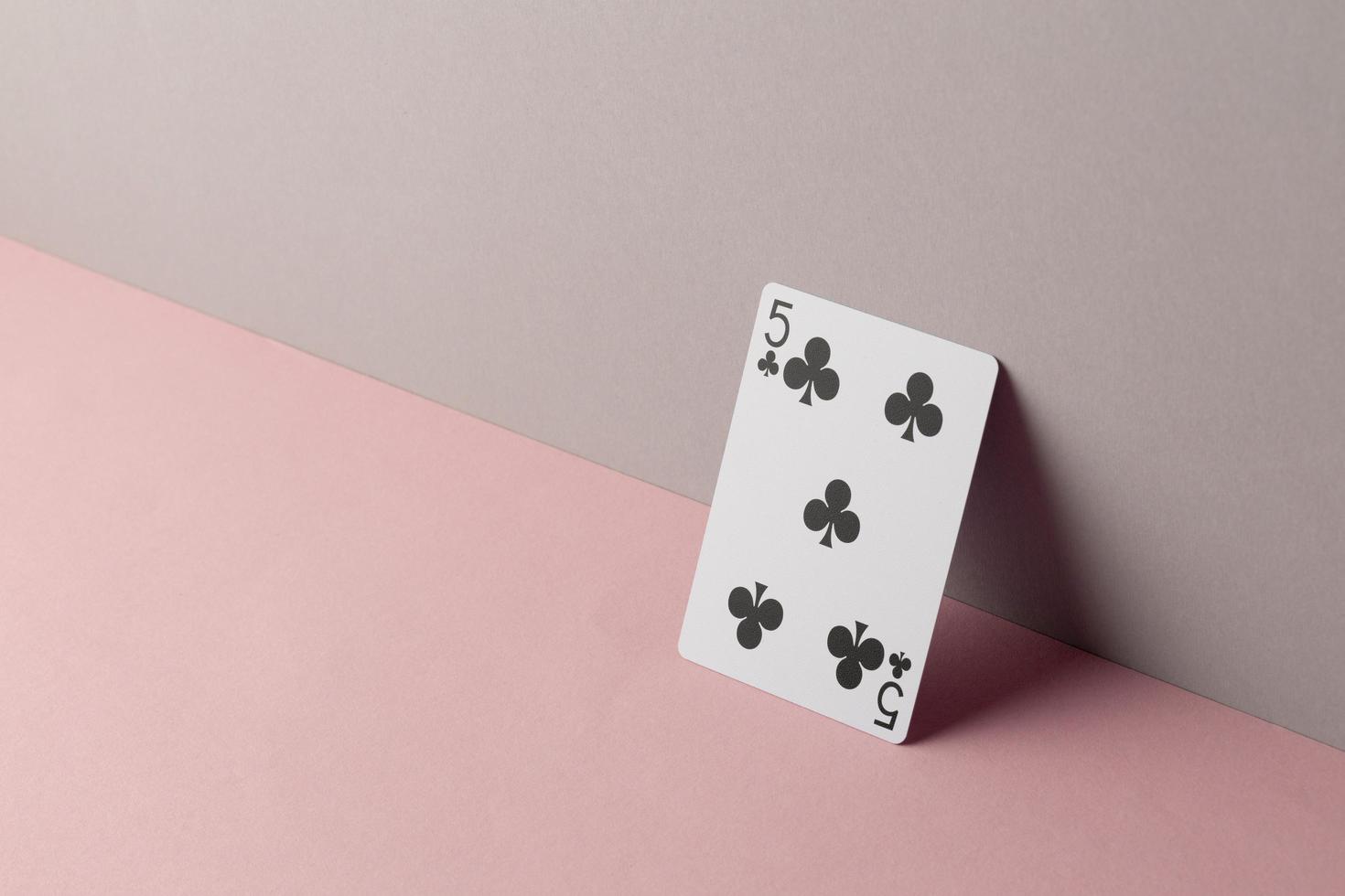 Five of clubs on pink background photo