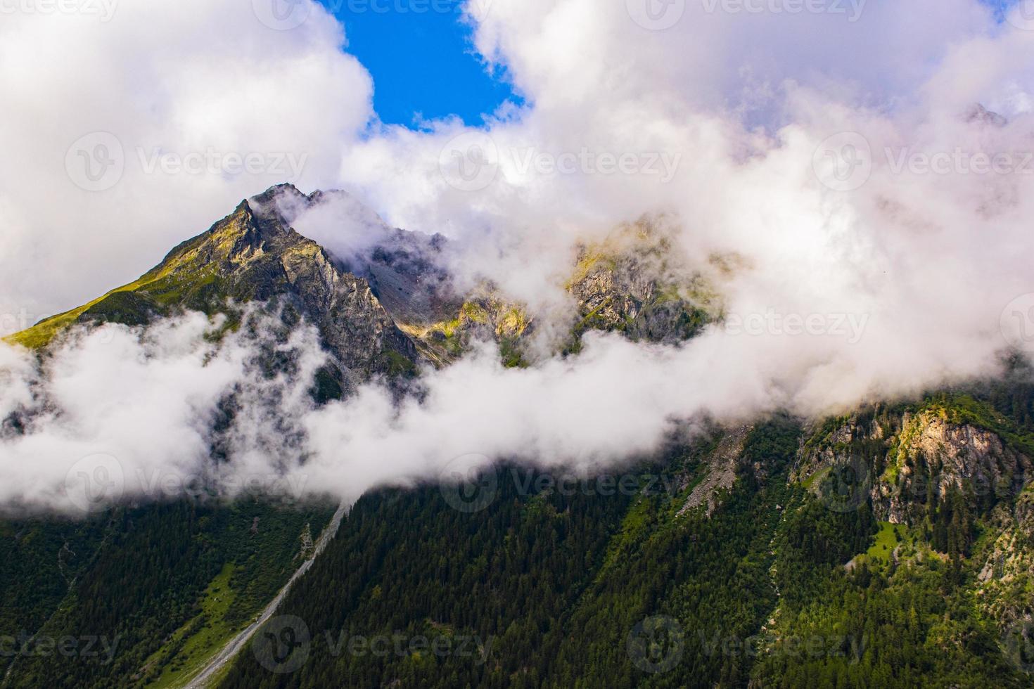Peaks surrounded by clouds in the Otztal valley in the Austrian Alps of Tyrol photo