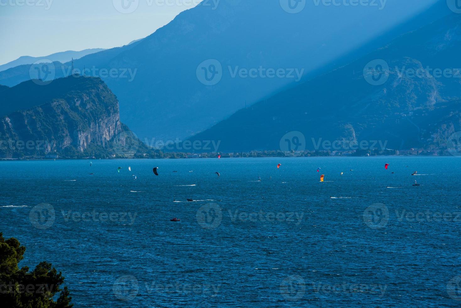 Kitesurfing in the early morning on Lake Garda at Limone sul Garda, Italy photo