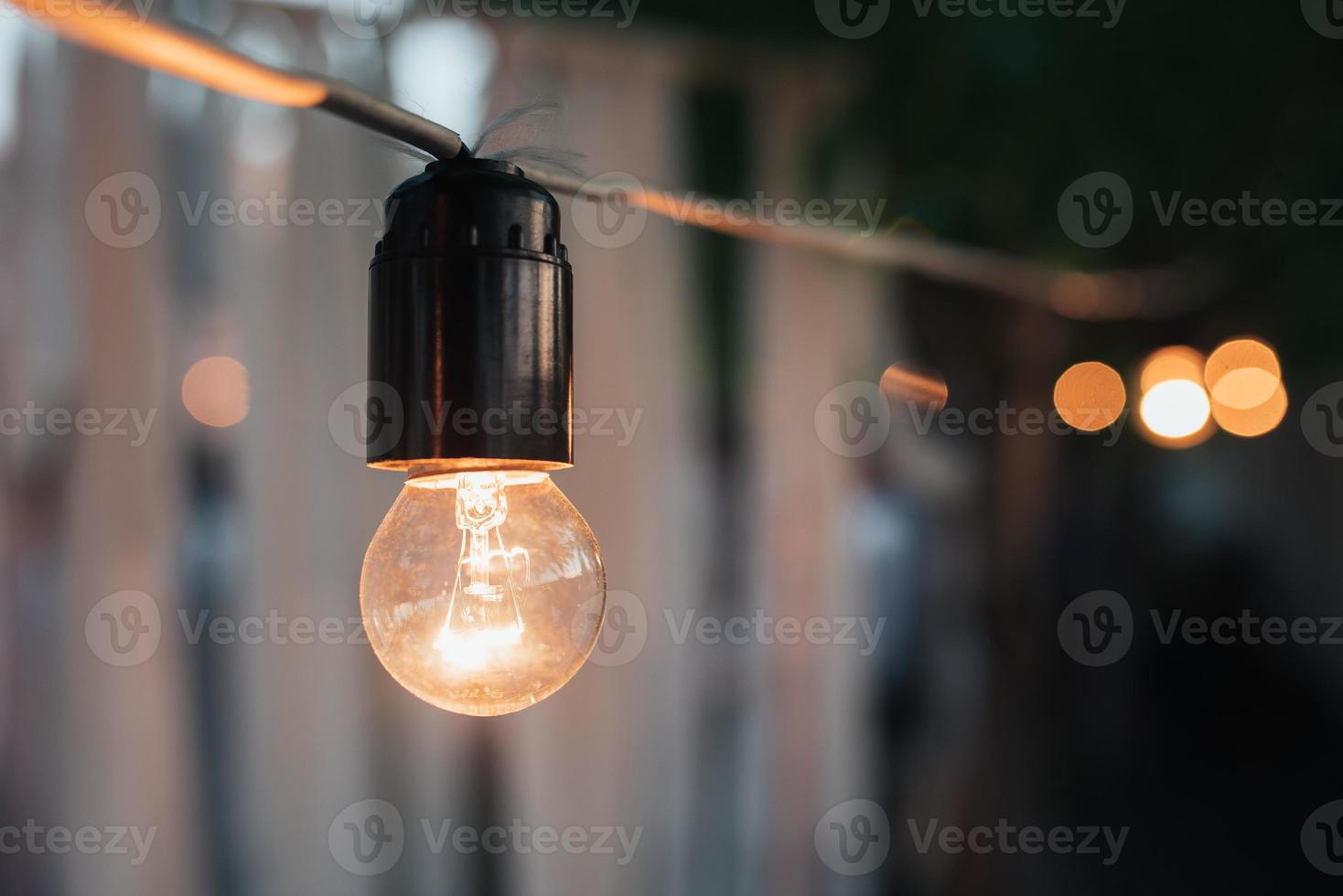 Decorative garland of old incandescent bulbs at night photo