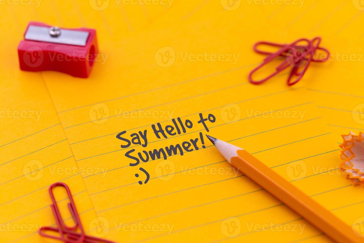 Concept of hello summer on yellow stationary photo