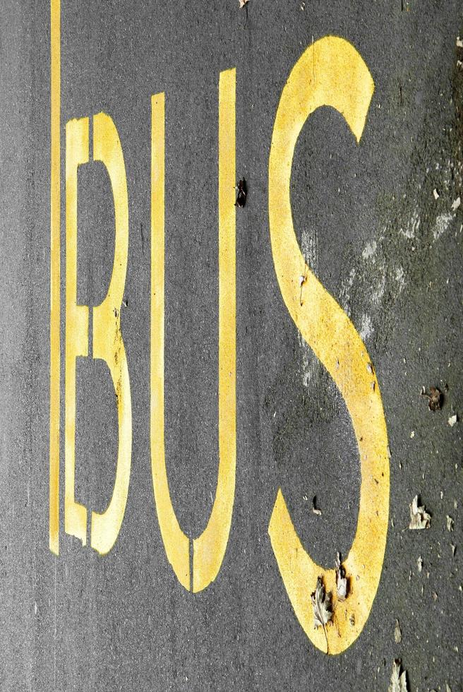 Bus stop with yellow text photo