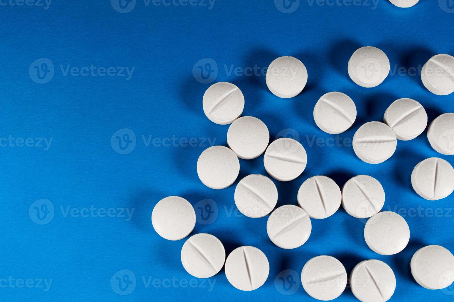 White medical pills and tablets with bottle photo