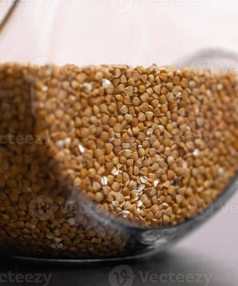 Buckwheat in a glass jar on the table photo