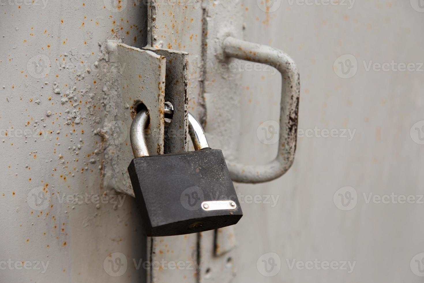 Background of door with lock in metal material and copyspace on wall photo