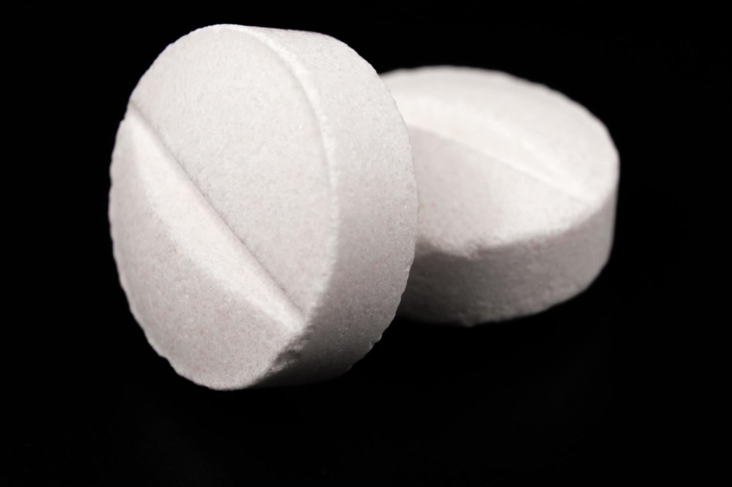 White medical pills and tablets with bottle photo