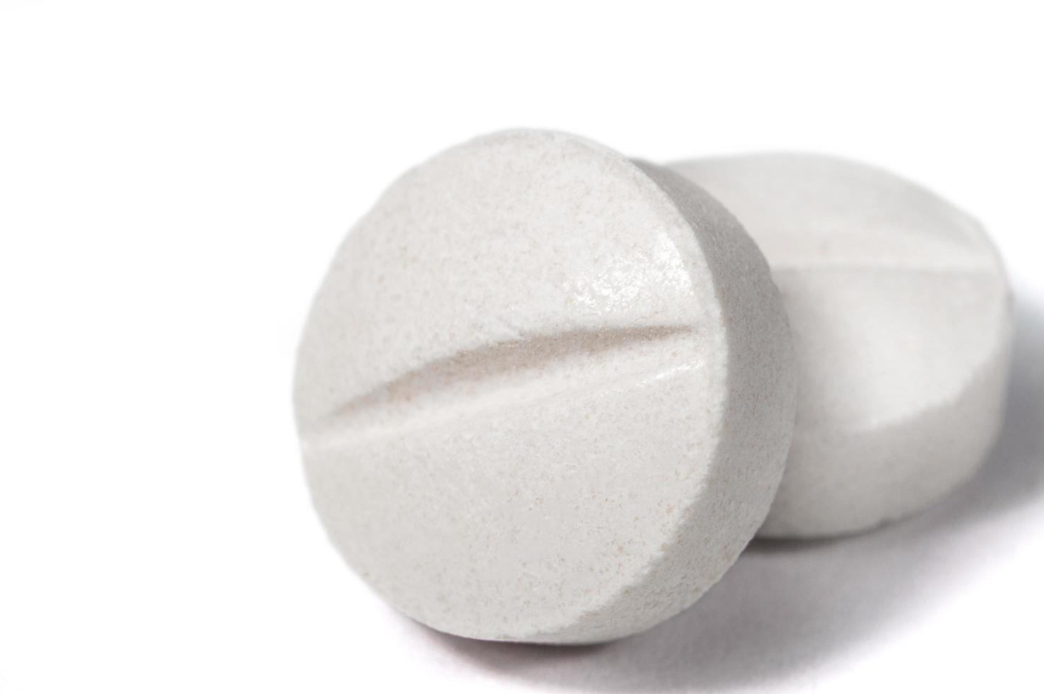 White medical pills and tablets with bottle photo