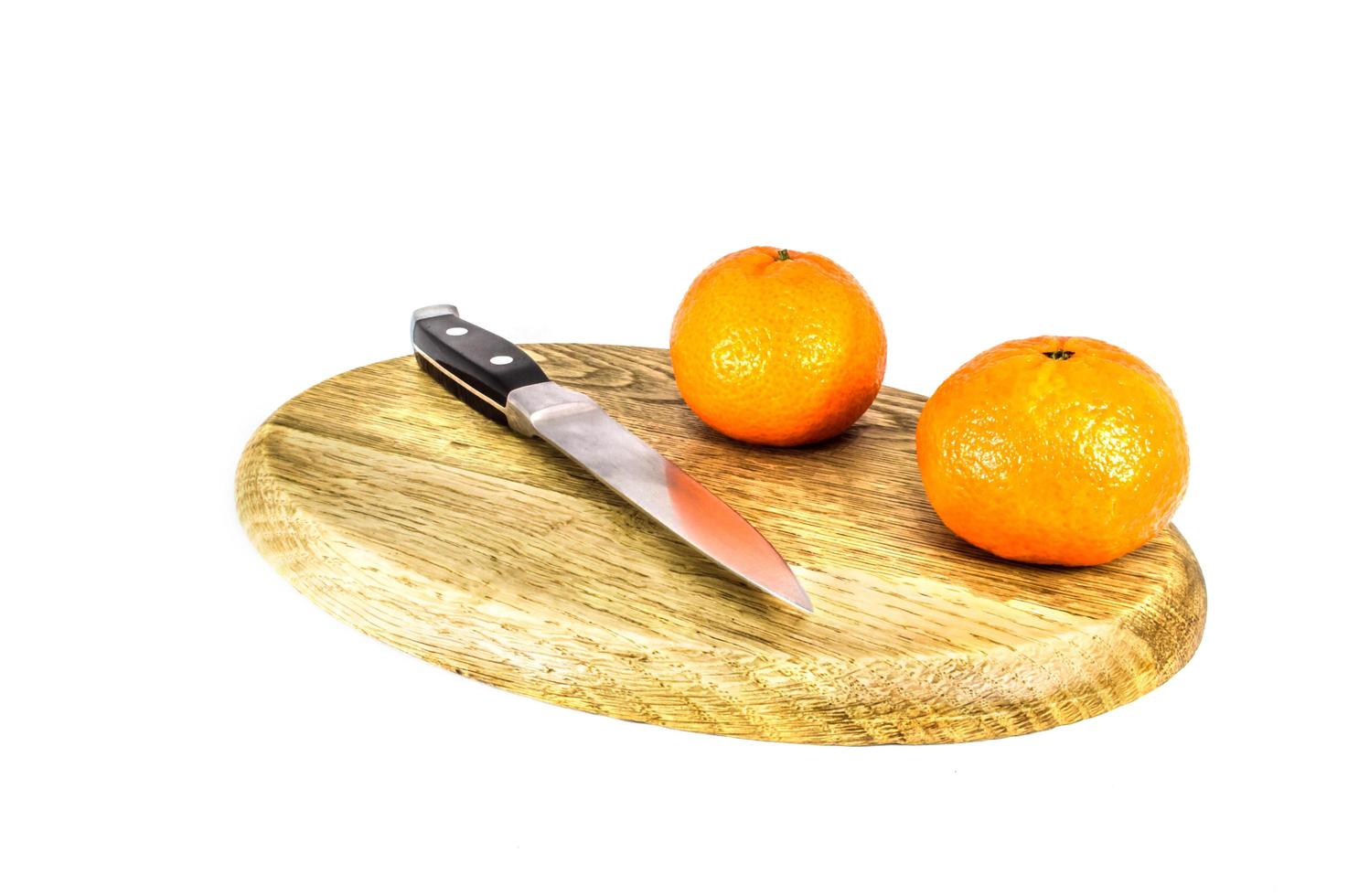 Orange mandarins on cutting board isolated on white background photo