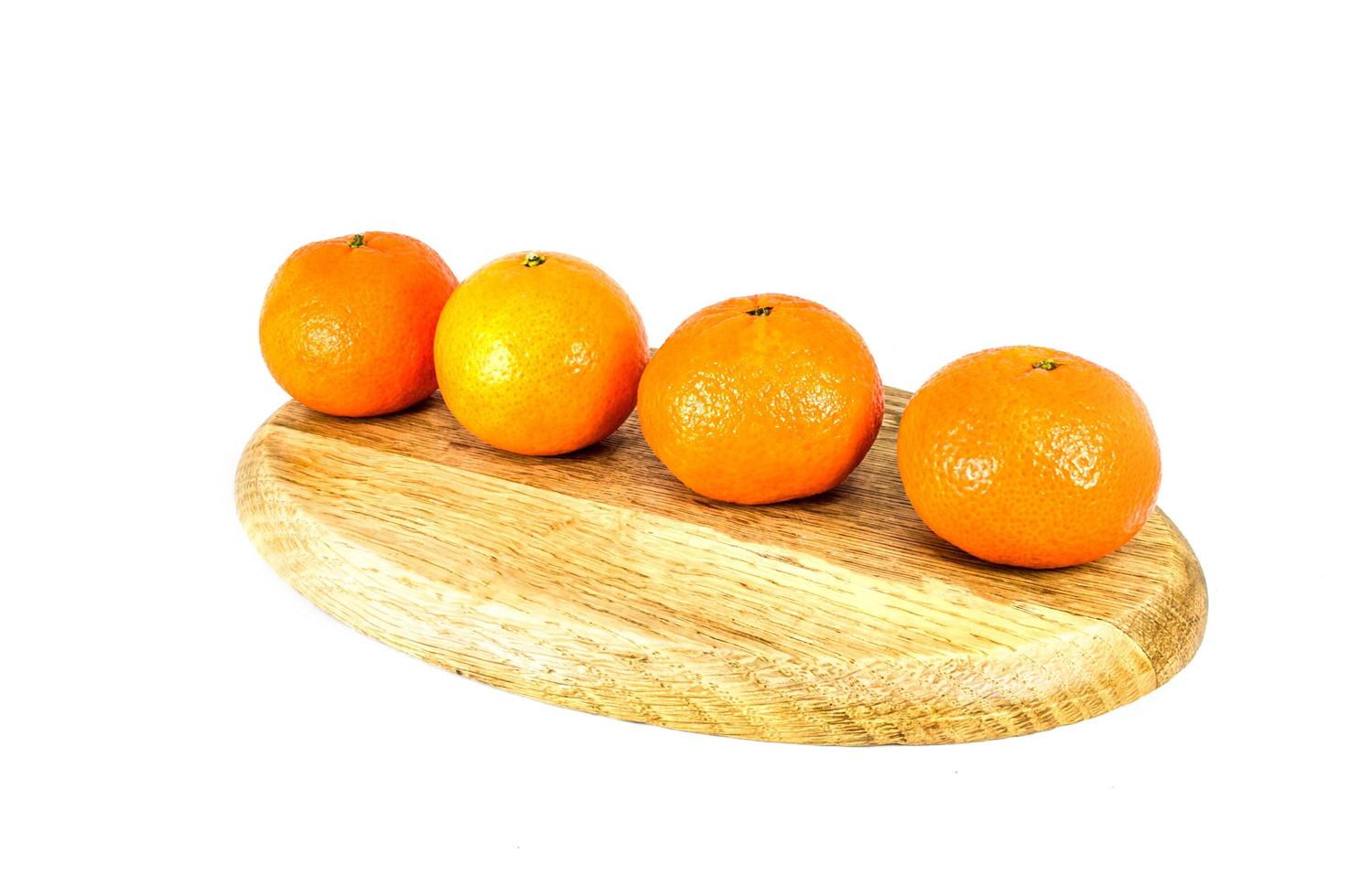 Orange mandarins on cutting board isolated on white background photo