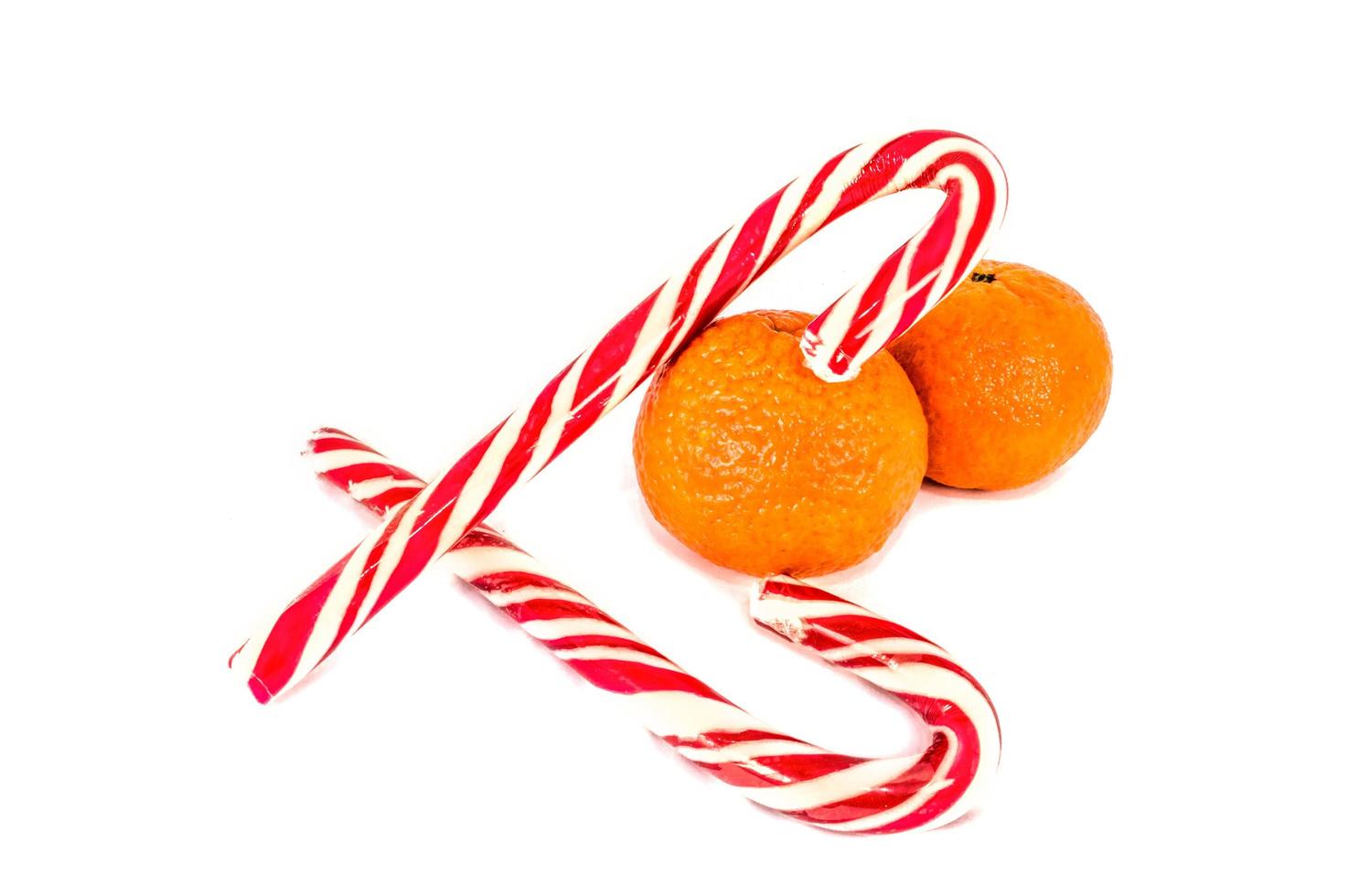 Orange mandarins with christmas baubles isolated on white background photo