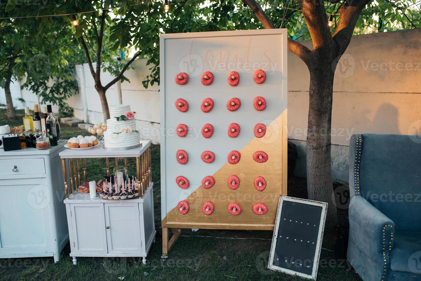 Stand with donuts in nature with a small table for text photo