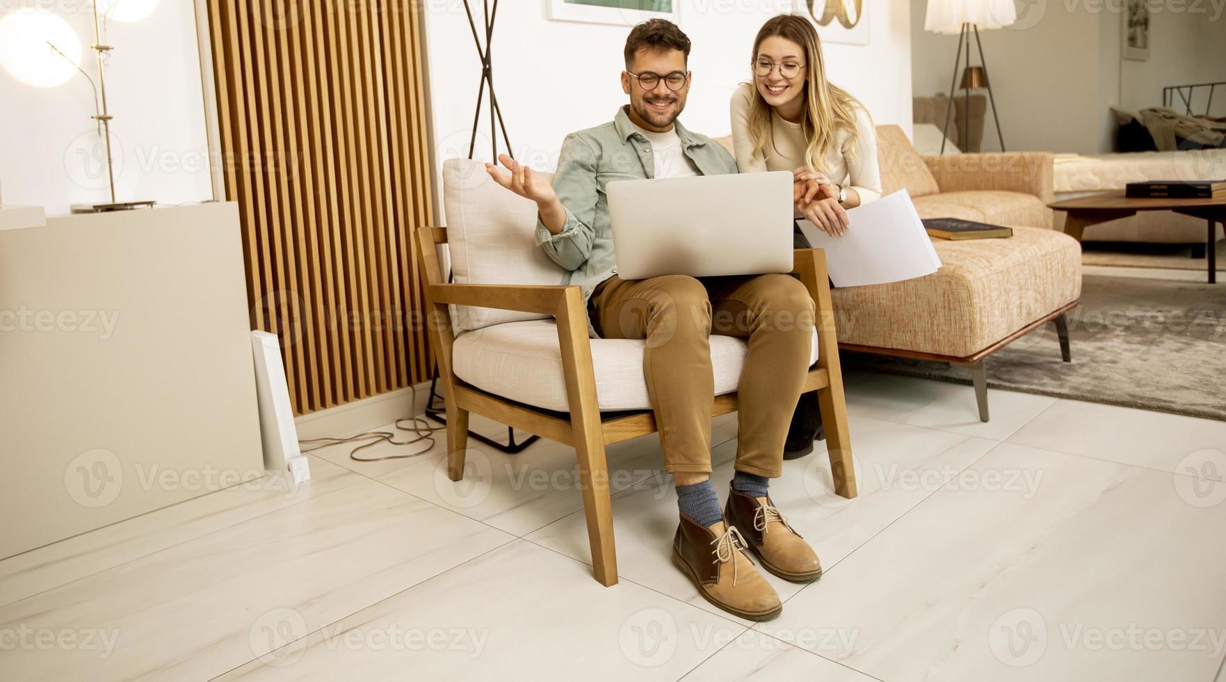 joven, usar la computadora portátil, en casa foto