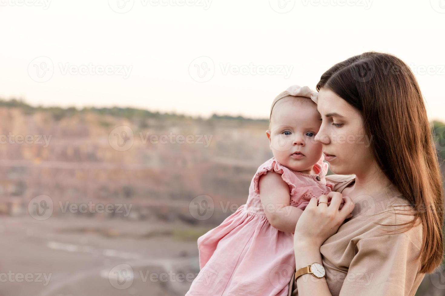 Mom holds her daughter in her arms photo