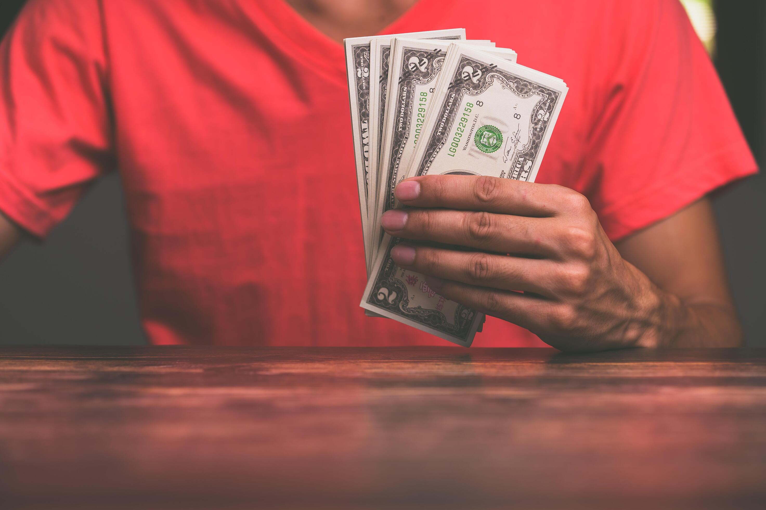 Business people hold cash notes 2429040 Stock Photo at Vecteezy