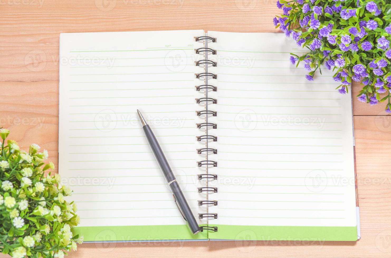 Spiral notebook on wood background photo