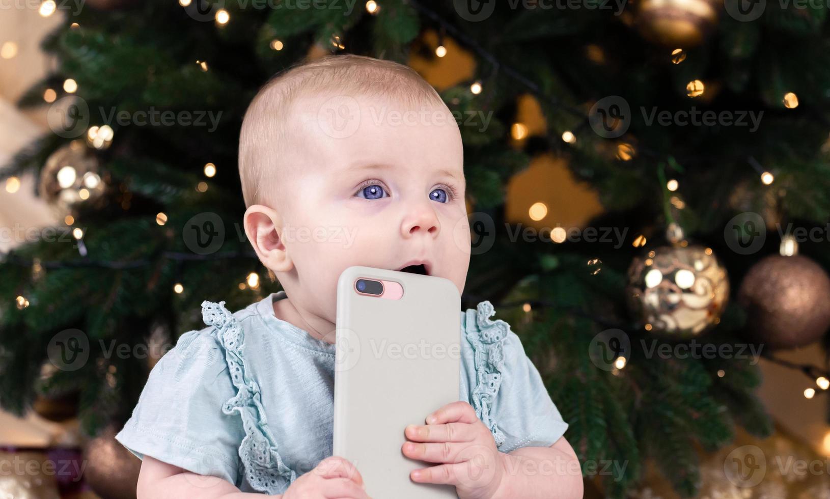 Christmas adorable small baby girl talking on the phone photo