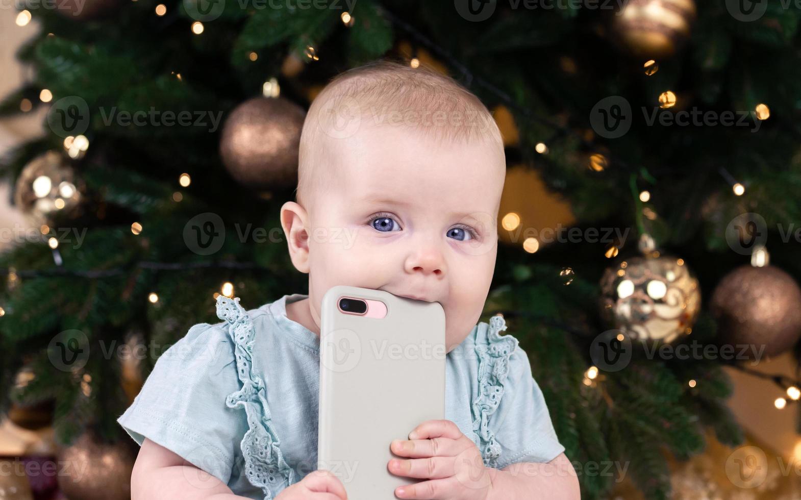 Christmas adorable small baby girl talking on the phone photo