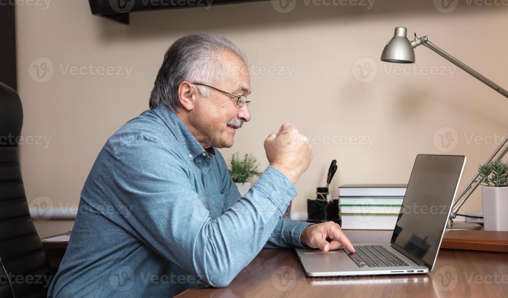 Senior man learns to use the computer photo