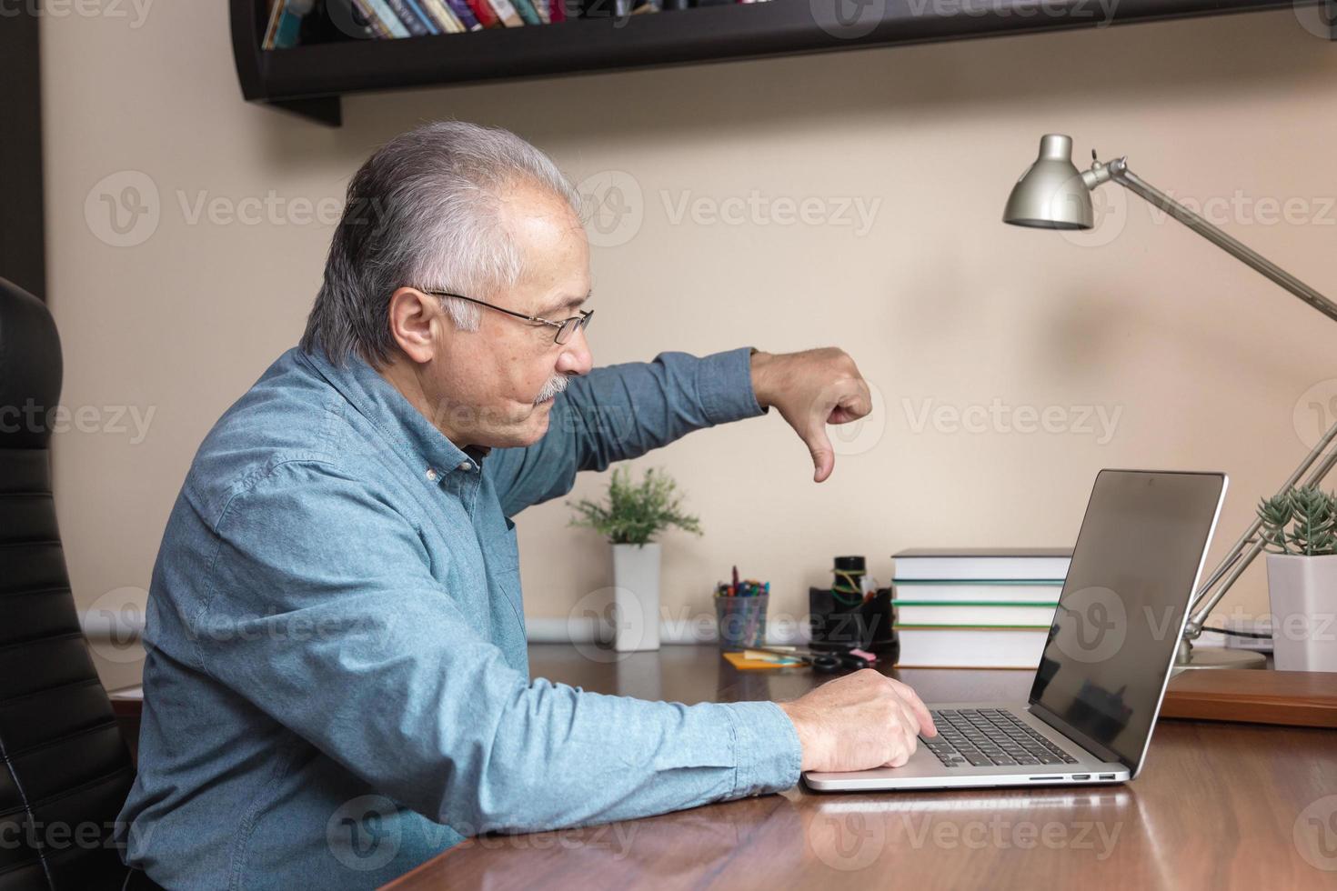 Senior man learns to use the computer photo