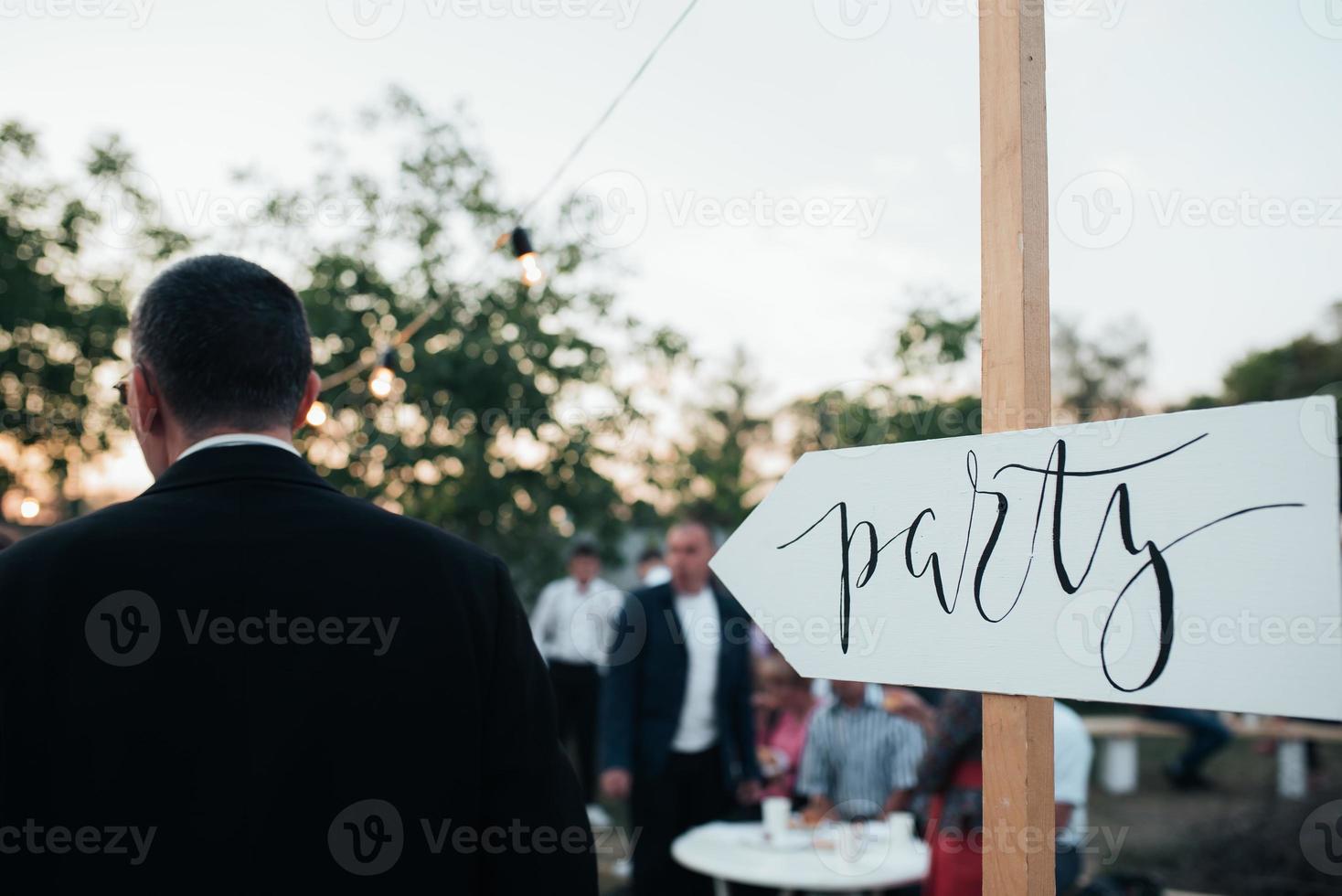 Group of people on nature and pointing arrow with text party photo