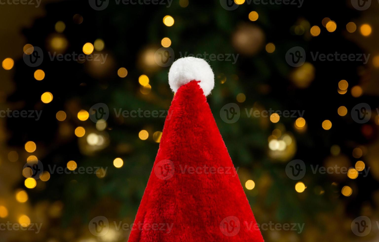 Santa hat on the background of a Christmas tree and garlands photo