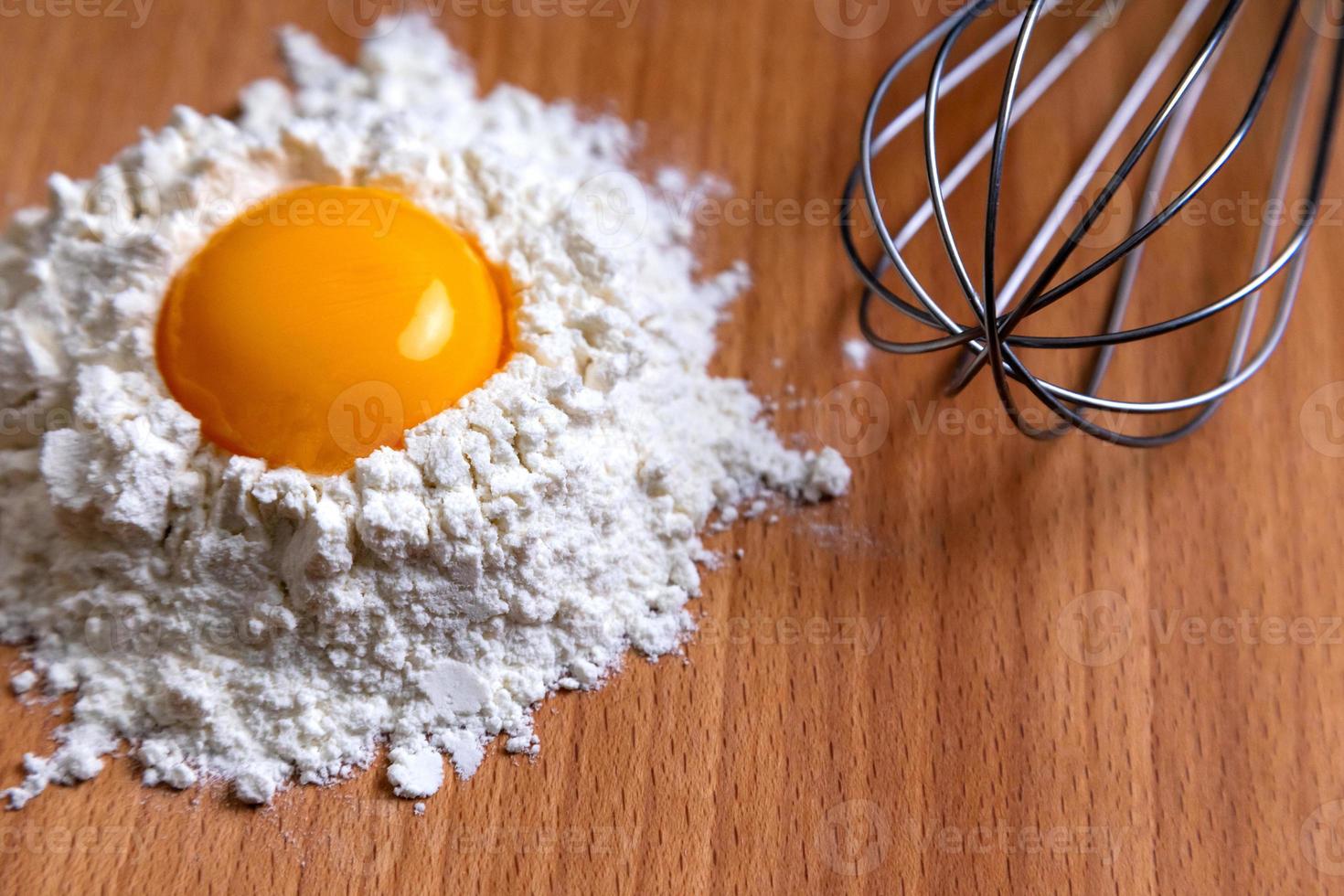 Cooking ingredients and kitchen tools on wood table photo