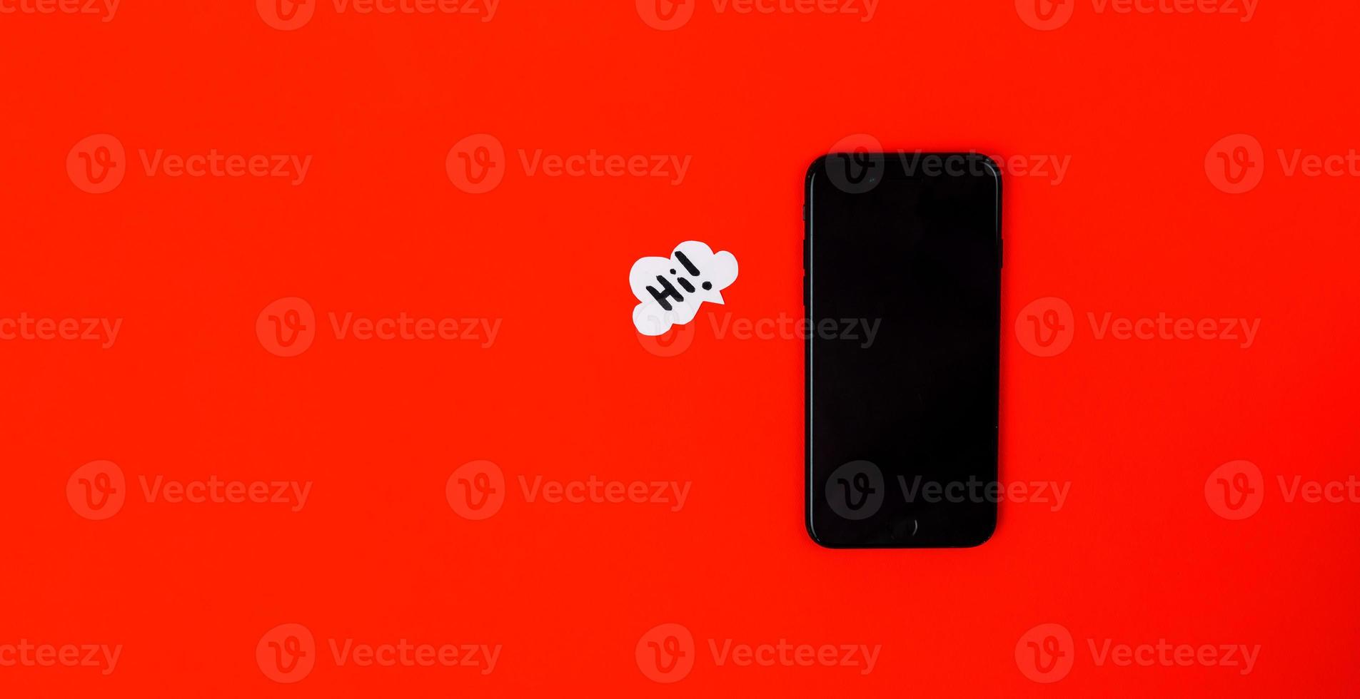 Smartphones with paper speech bubbles on red background photo