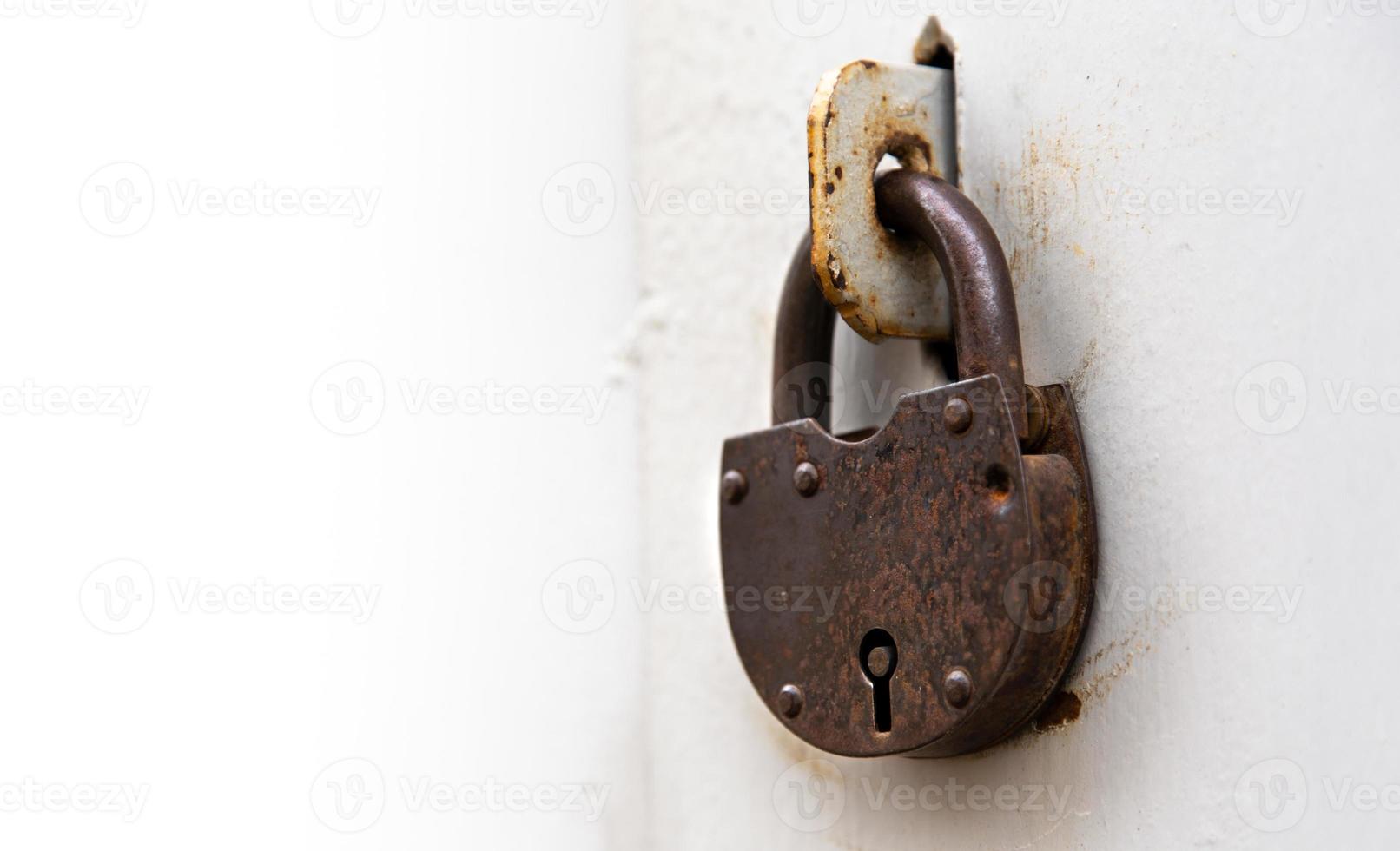 Background of door with lock in metal material and copyspace on wall photo