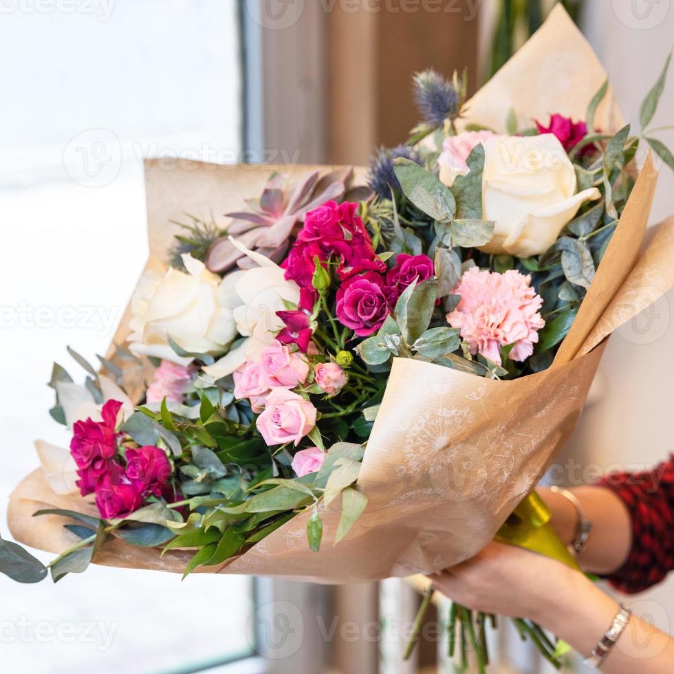 Florist woman holding beautiful flower bouquet photo