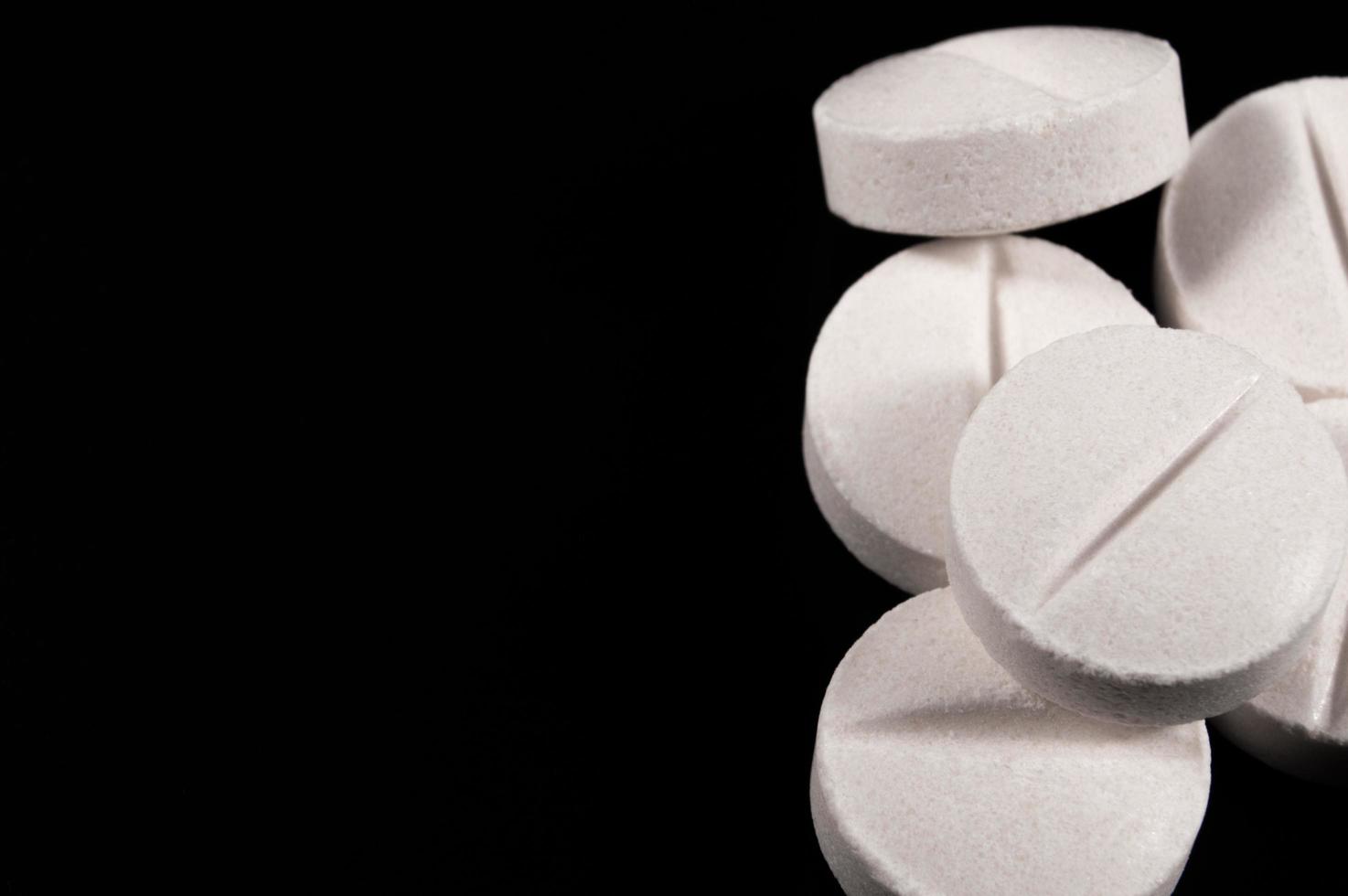 White medical pills and tablets with bottle photo
