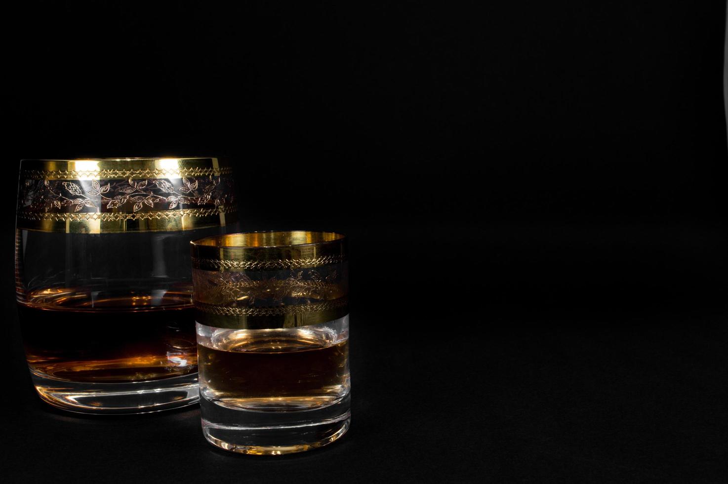 Glass of dark red whiskey brandy or bourbon photo
