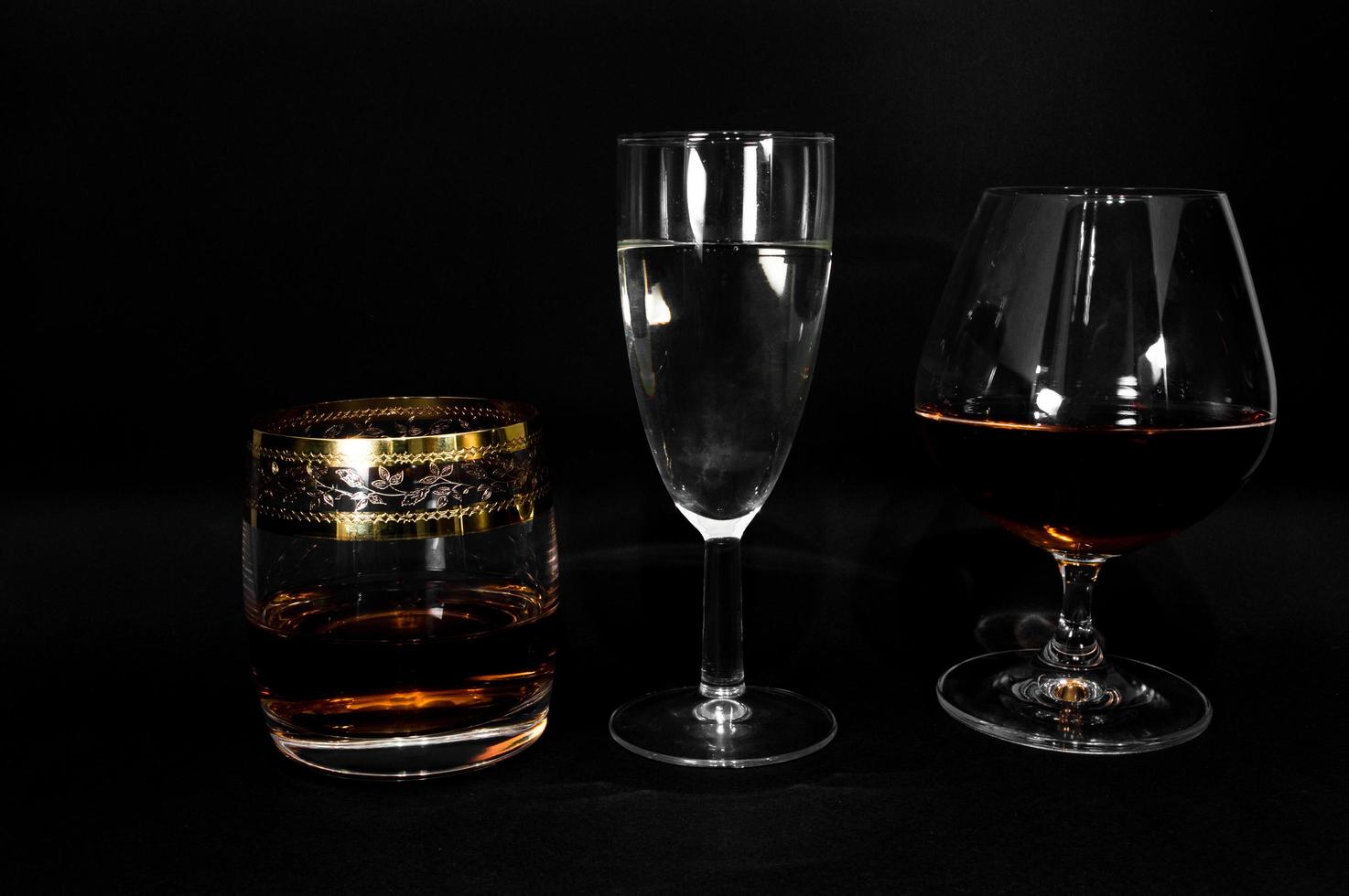 Glasses with different drinks brandy whiskey champagne or bourbon photo
