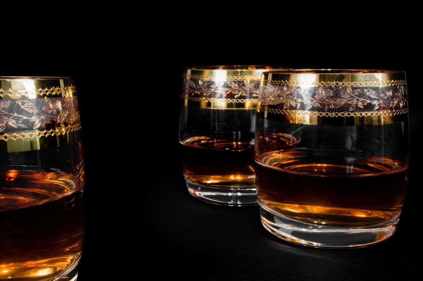 Glass of dark red whiskey brandy or bourbon photo