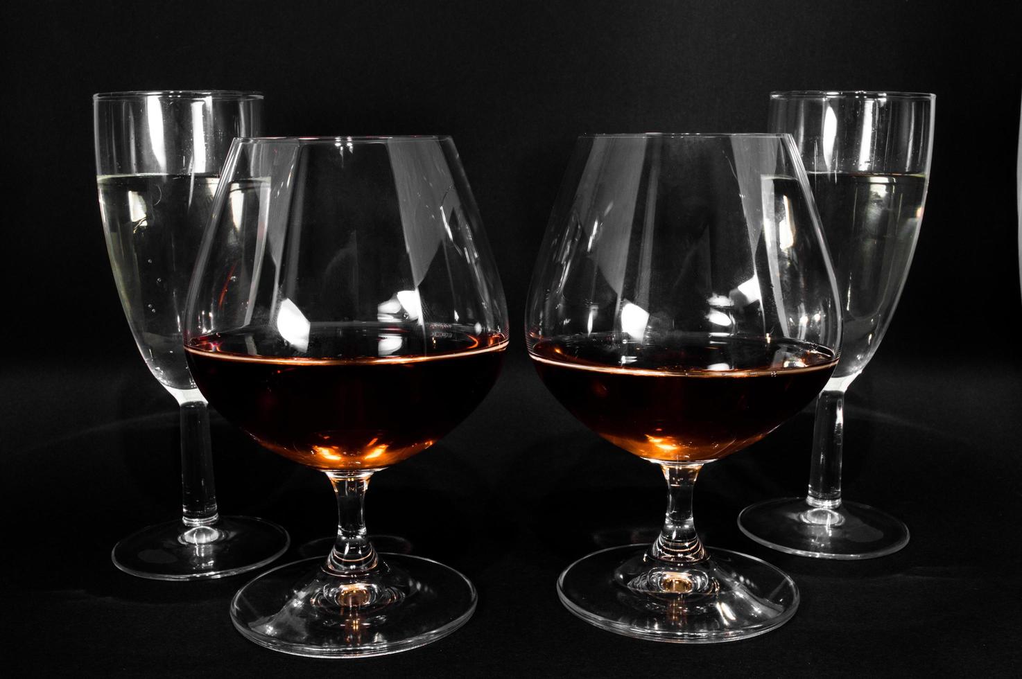 Glasses with different drinks brandy whiskey champagne or bourbon photo