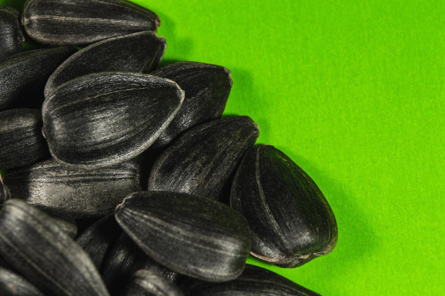 Sunflower seeds in  macro on green background photo