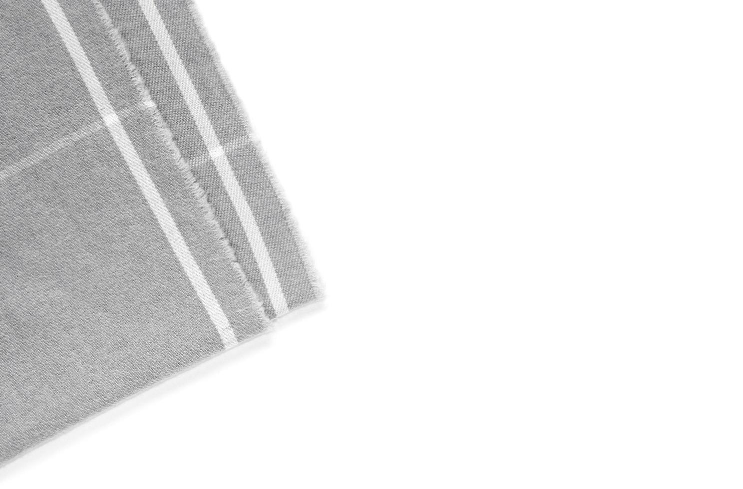 A piece of gray checked fabric isolated on a white background with an area for text photo