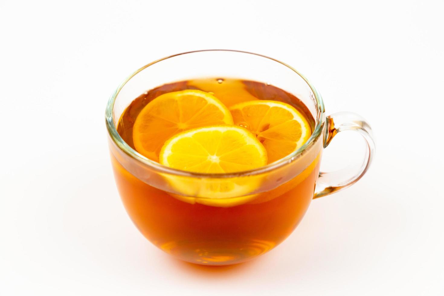 Tea in cup with leaf mint and lemon isolated on white background photo