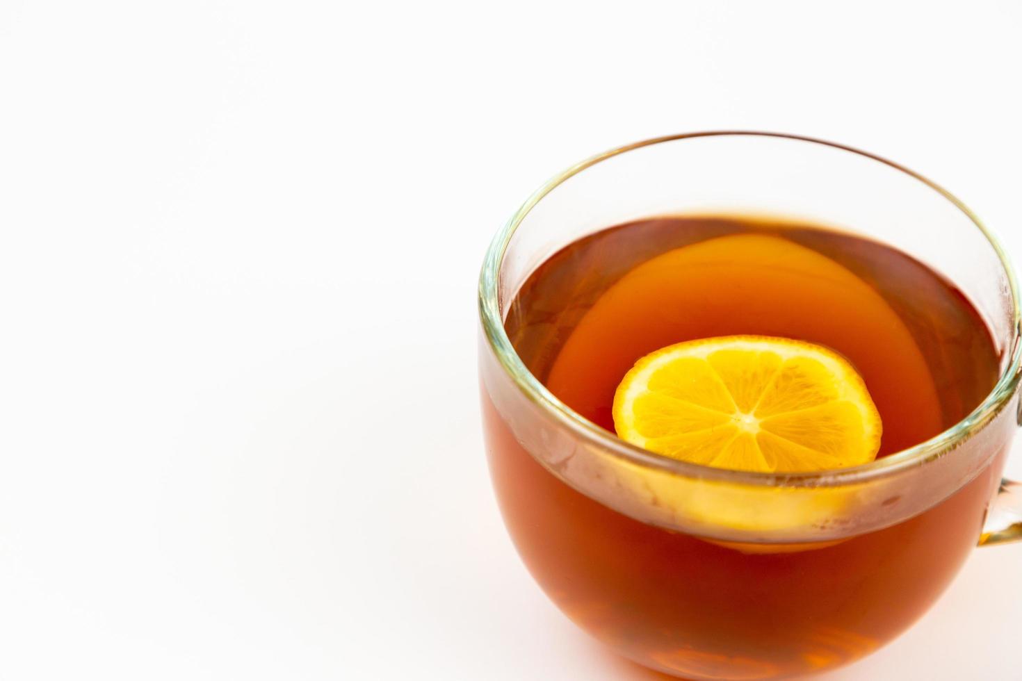 Tea in cup with leaf mint and lemon isolated on white background photo
