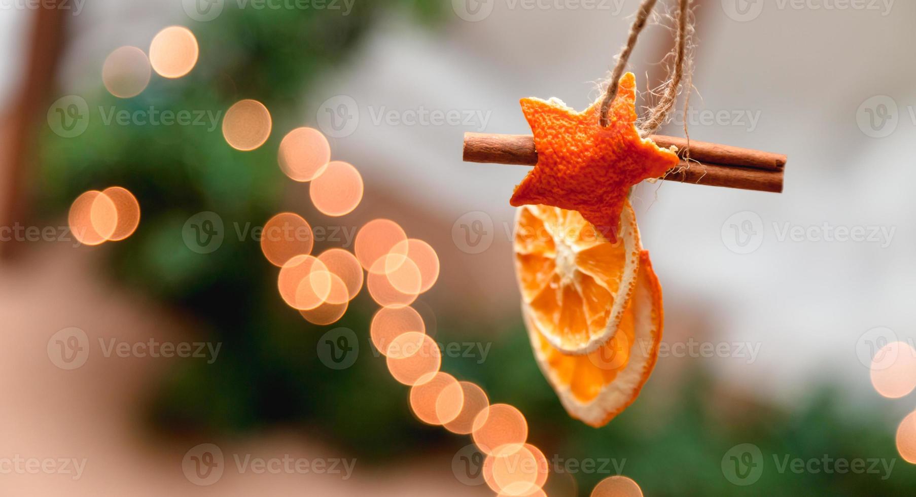 Hanging Christmas decoration of dried oranges tangerine and cinnamon stars photo
