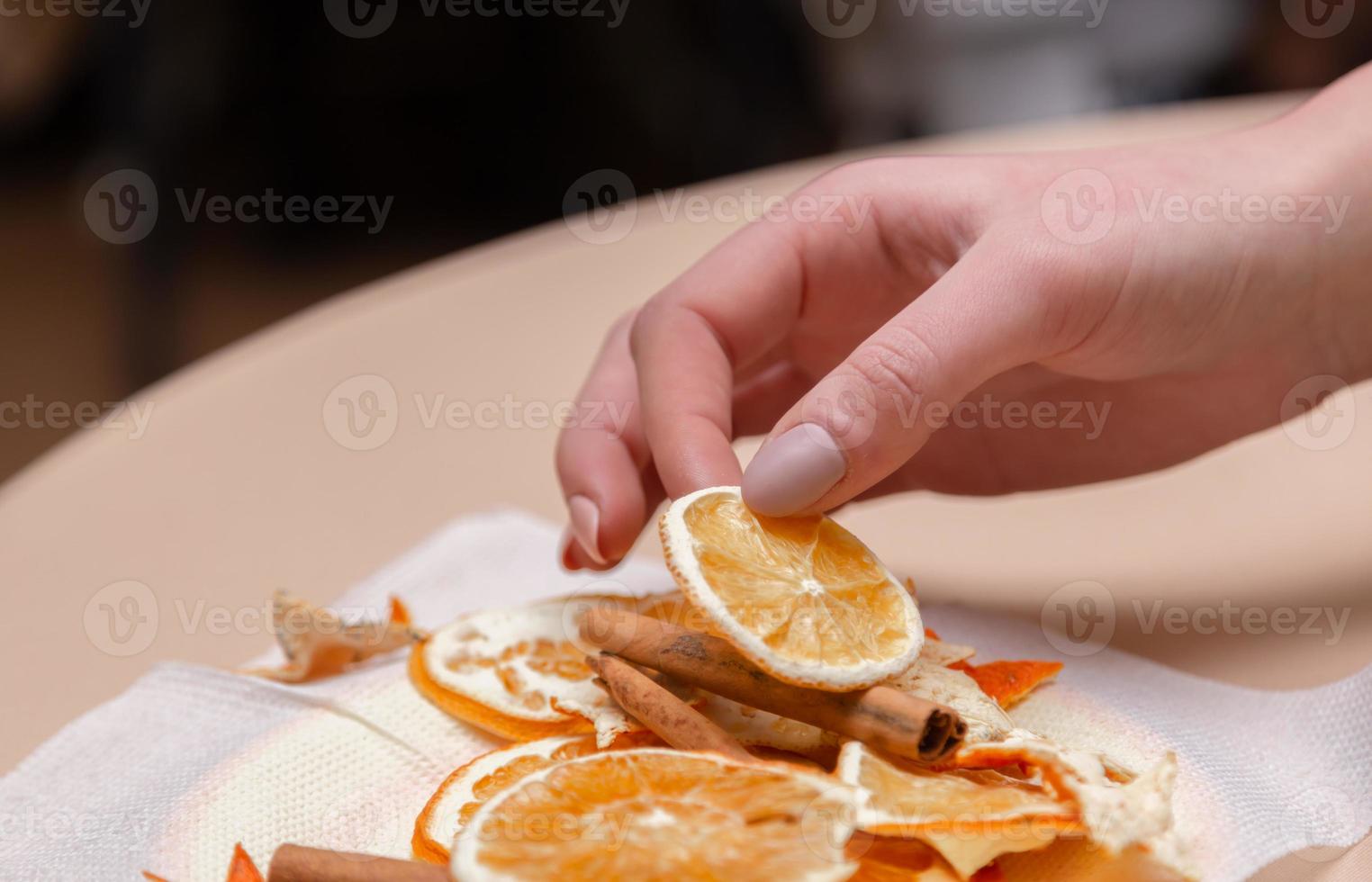 Women hand making decorations from dried oranges photo