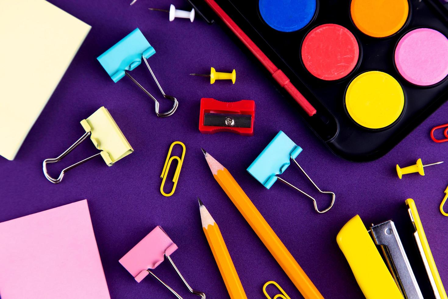 School office supplies on a purple background desk photo