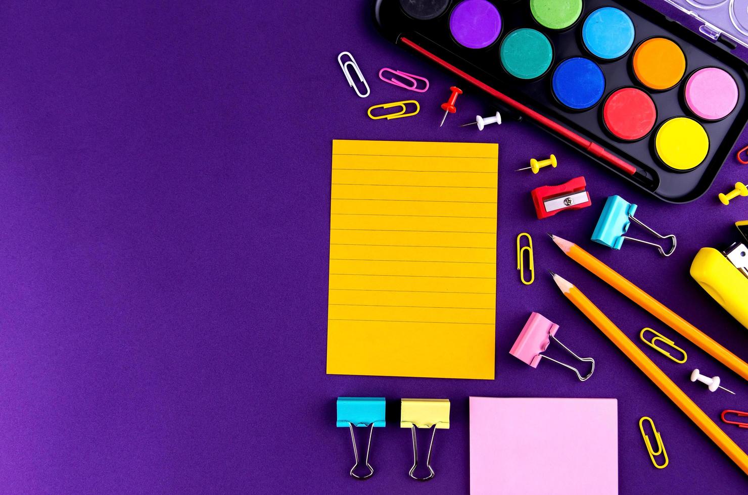 School office supplies on a purple background desk photo