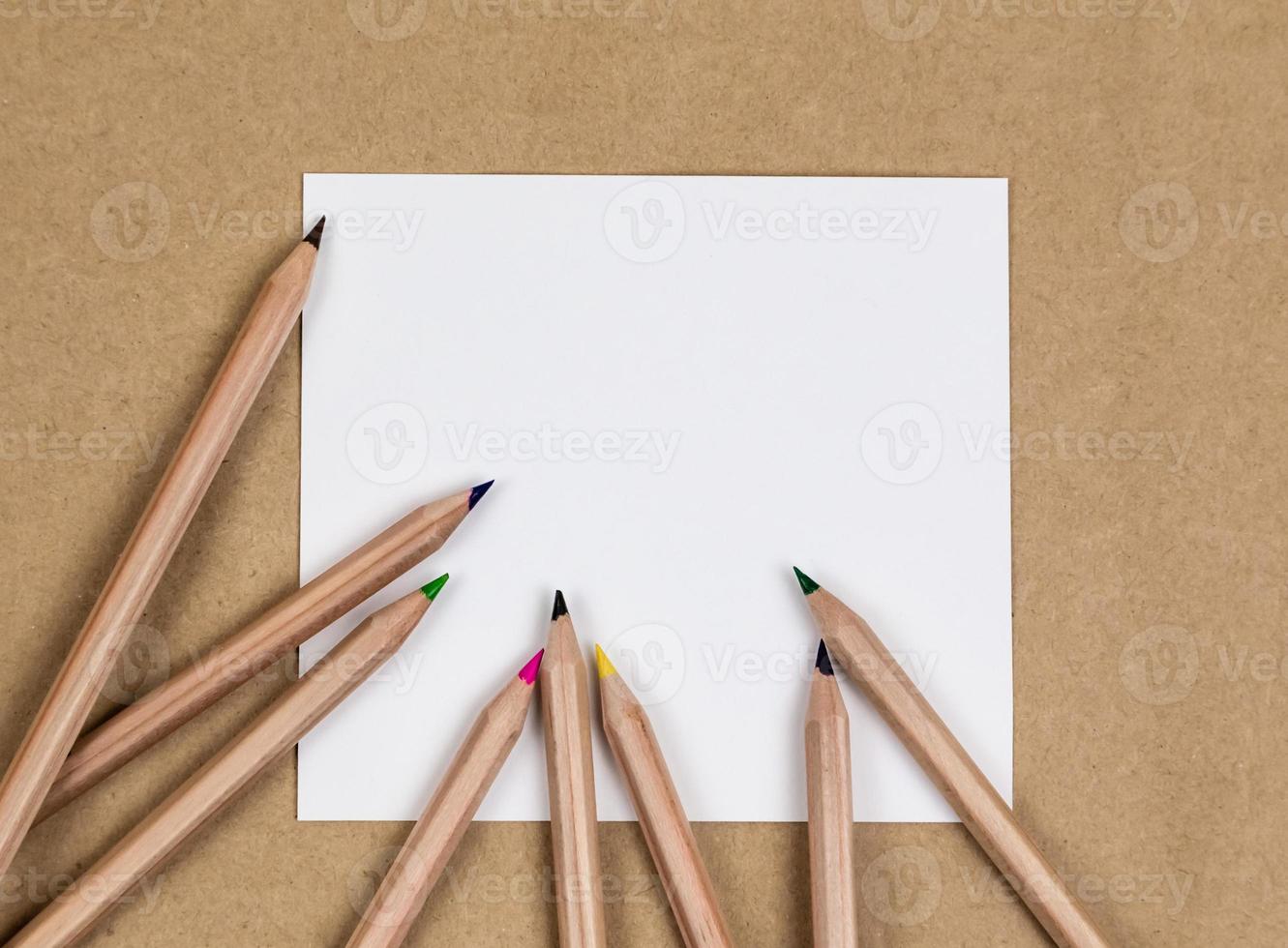 Blank notebook page with colorful pencils photo