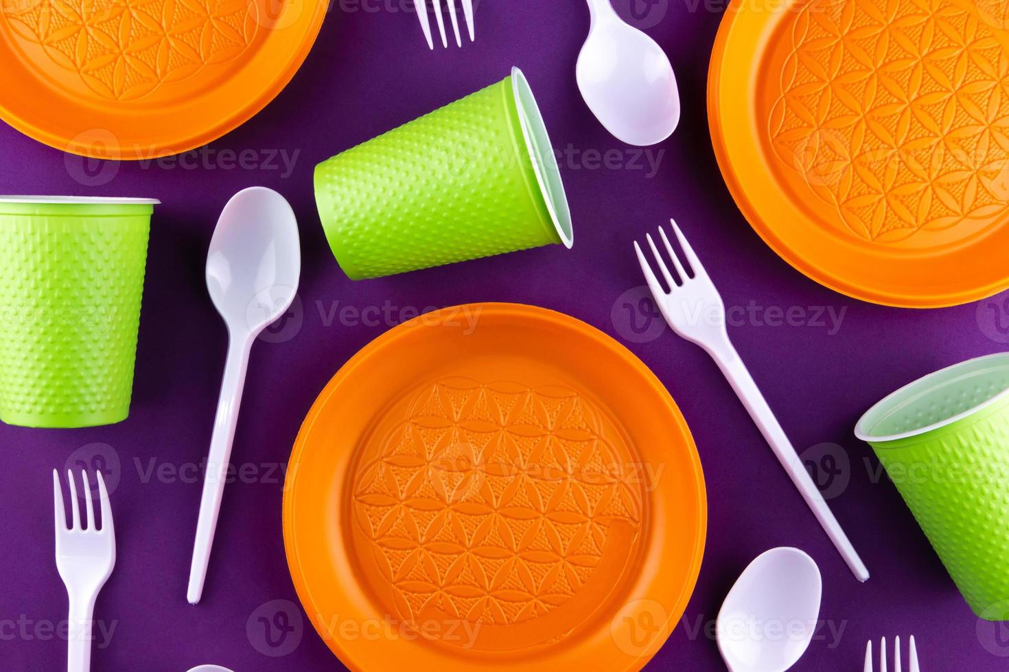 Plastic orange green waste collection on purple background photo