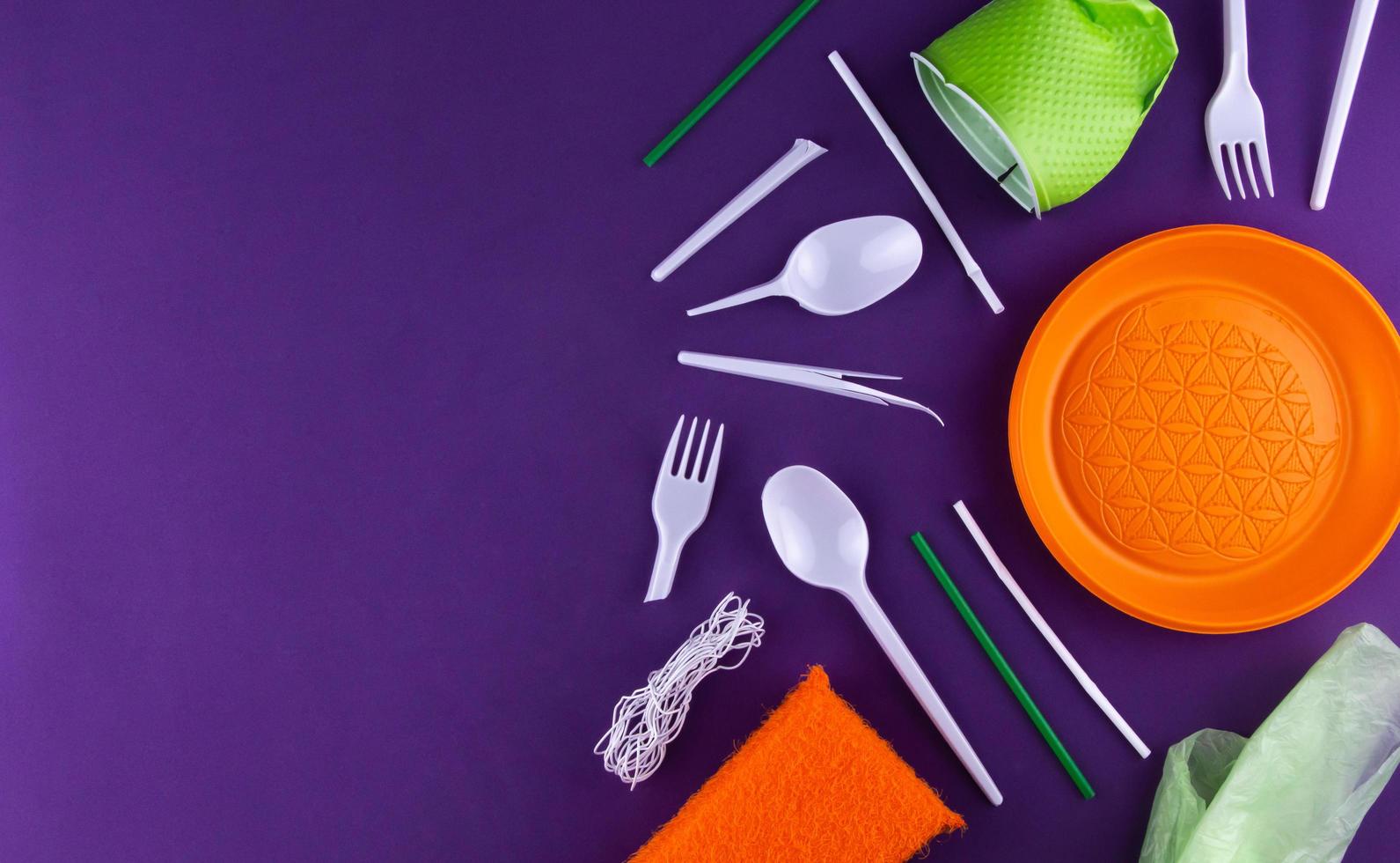 Orange, white and green packaging plastic products on purple background photo