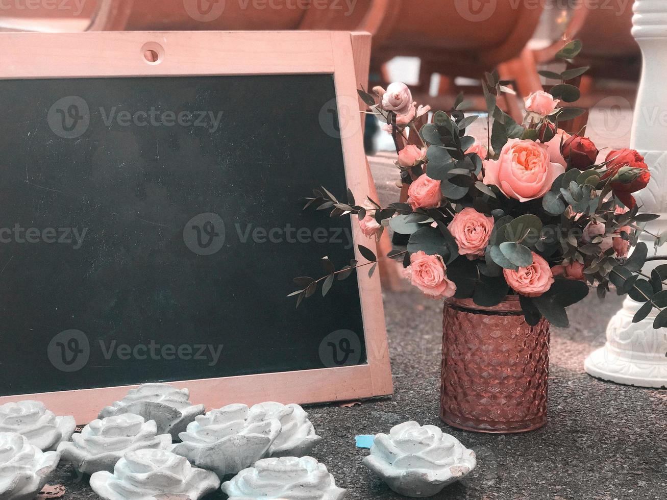 A bouquet in a rustic style with a frame and a black board for drawing a place for text photo