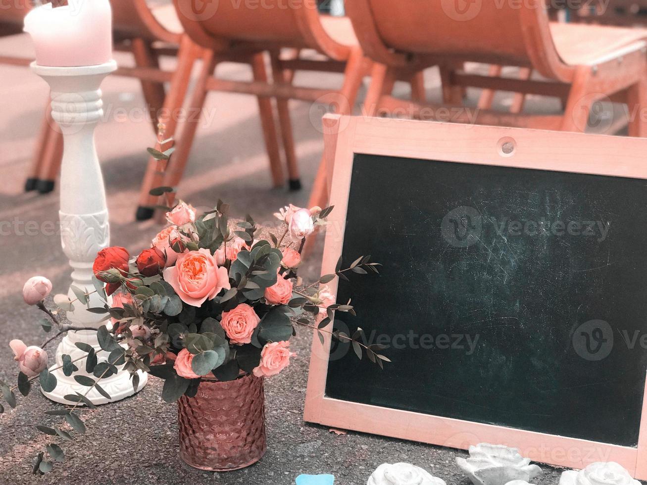 A bouquet in a rustic style with a frame and a black board for drawing a place for text photo