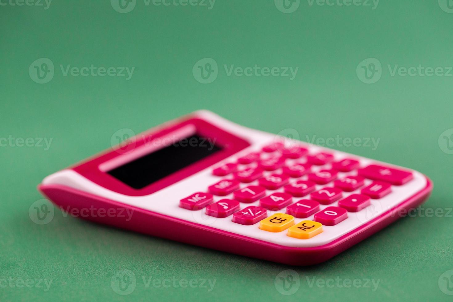Calculator isolated on green background photo